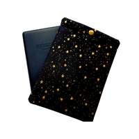 A pouch with a snap closure to protect Kindle e-readers made with black with gold metallic stars fabric.